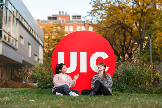 Two students with UIC logo on west campus